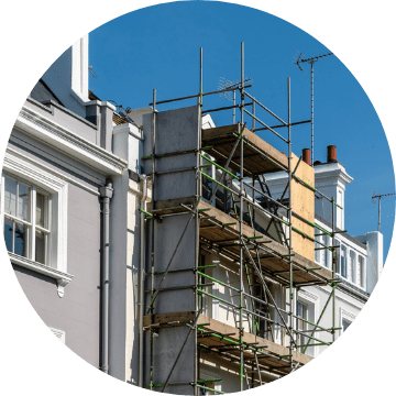 Cover repair costs. This image shows some scaffolding on the front of a white coloured house.