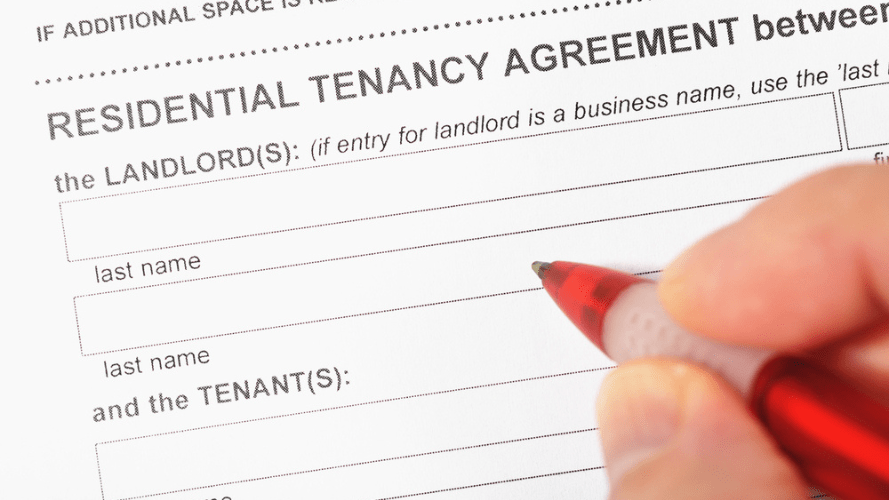 Landlord filling in their details on a tenancy agreement