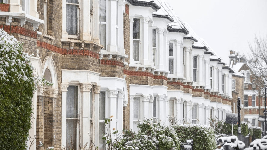 This photo shows a line of edwardian houses on a street.