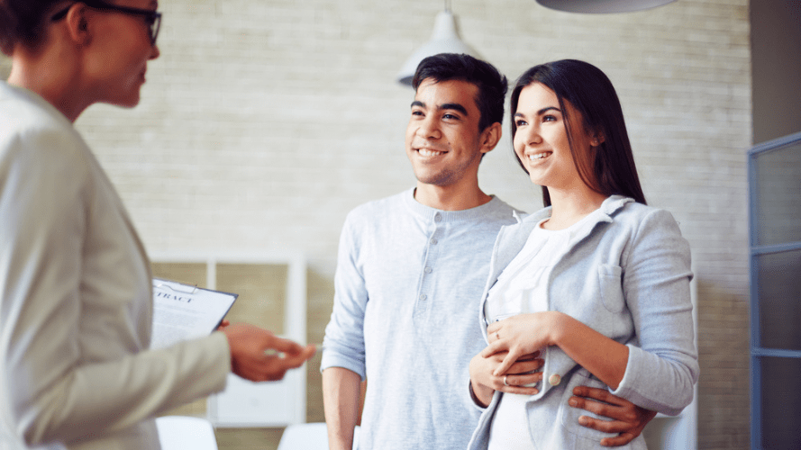 A couple discussing their rental agreement with a letting agent