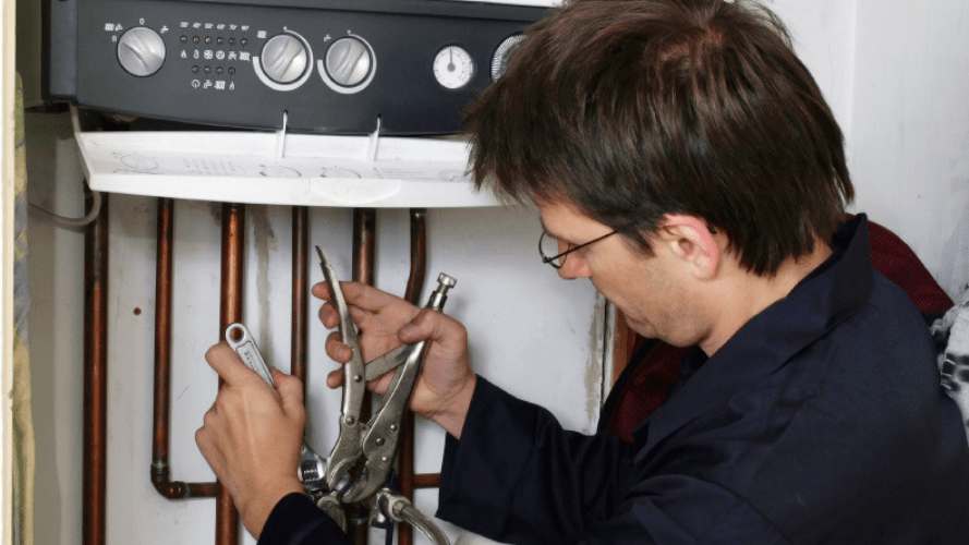 A repairman fixing the pipes at a rented property