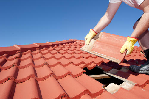 Roofer replacing tile